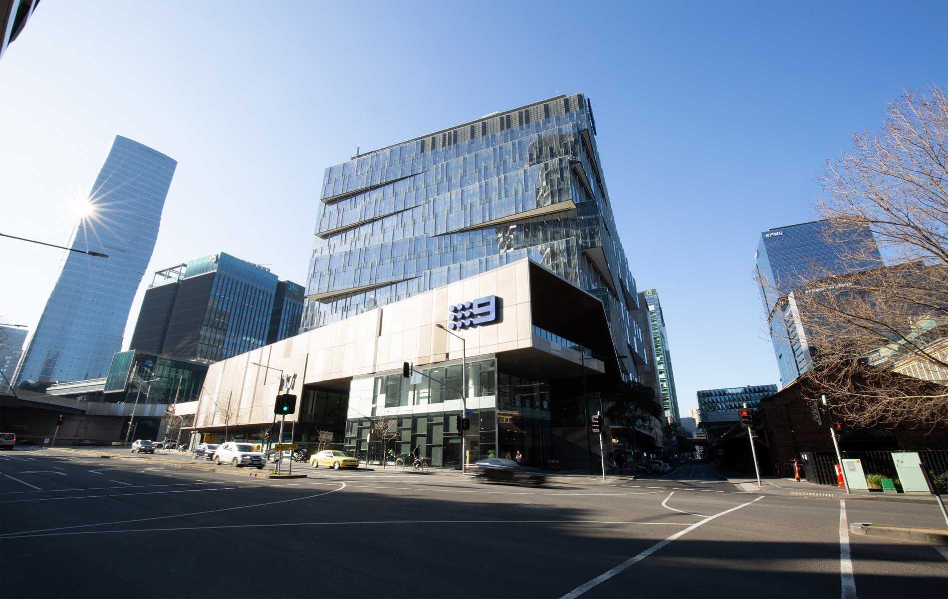 717 Bourke Street — the glass tower above its stone podium at the Docklands corner