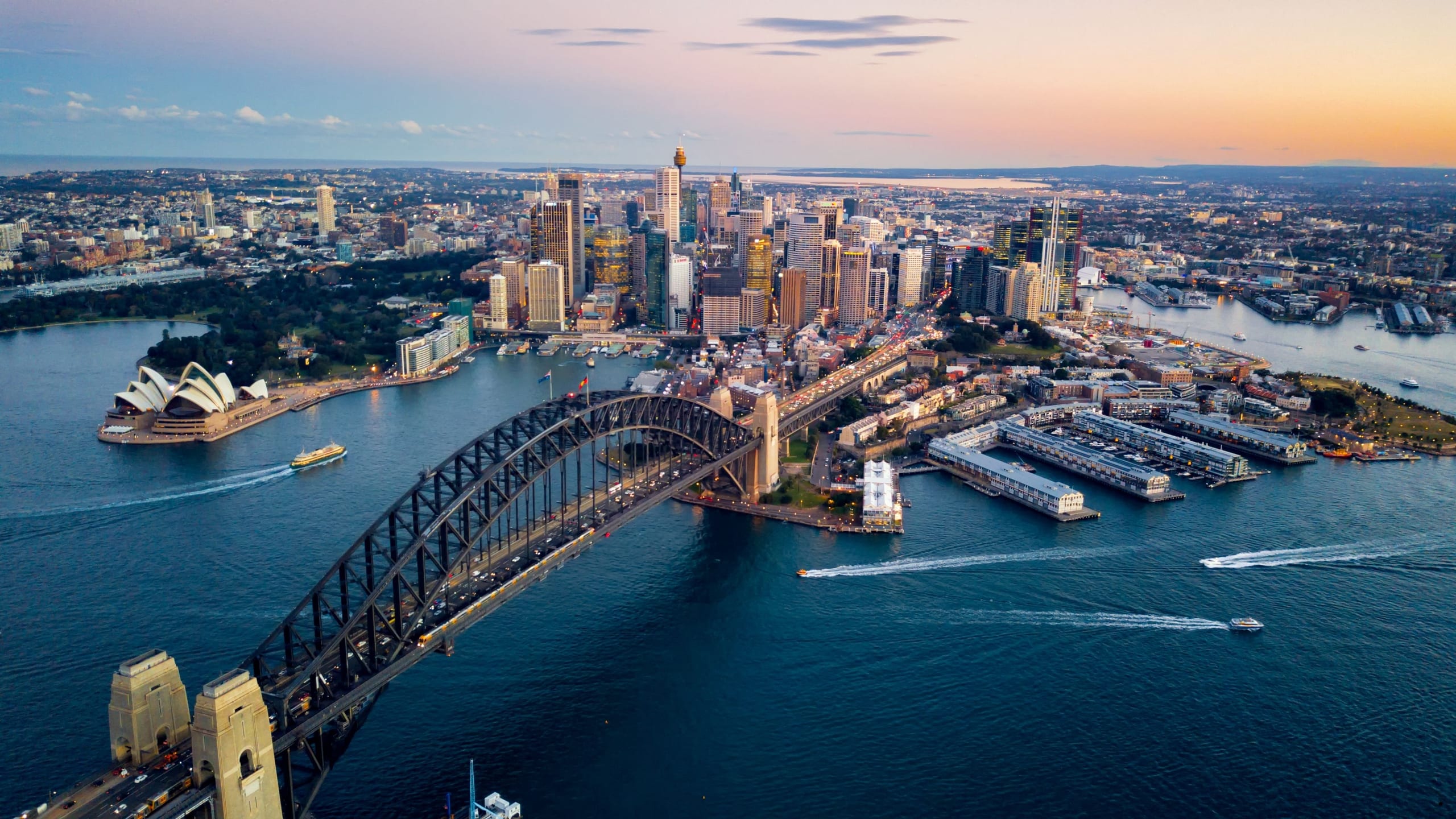 Dusk aerial over Sydney Harbour, the bridge and city carrying the Box Capital story