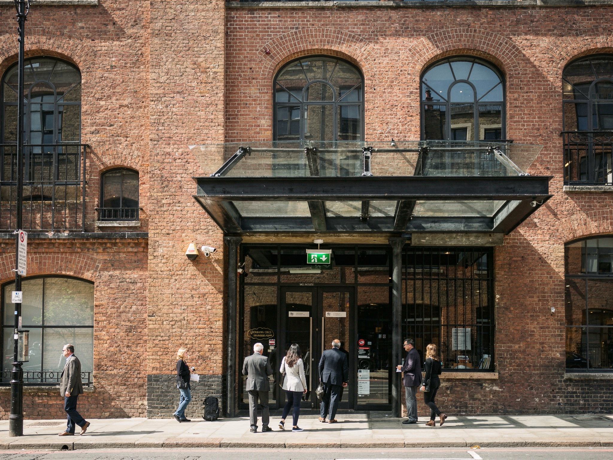 A blackened-steel and glass entrance canopy set into the red brick