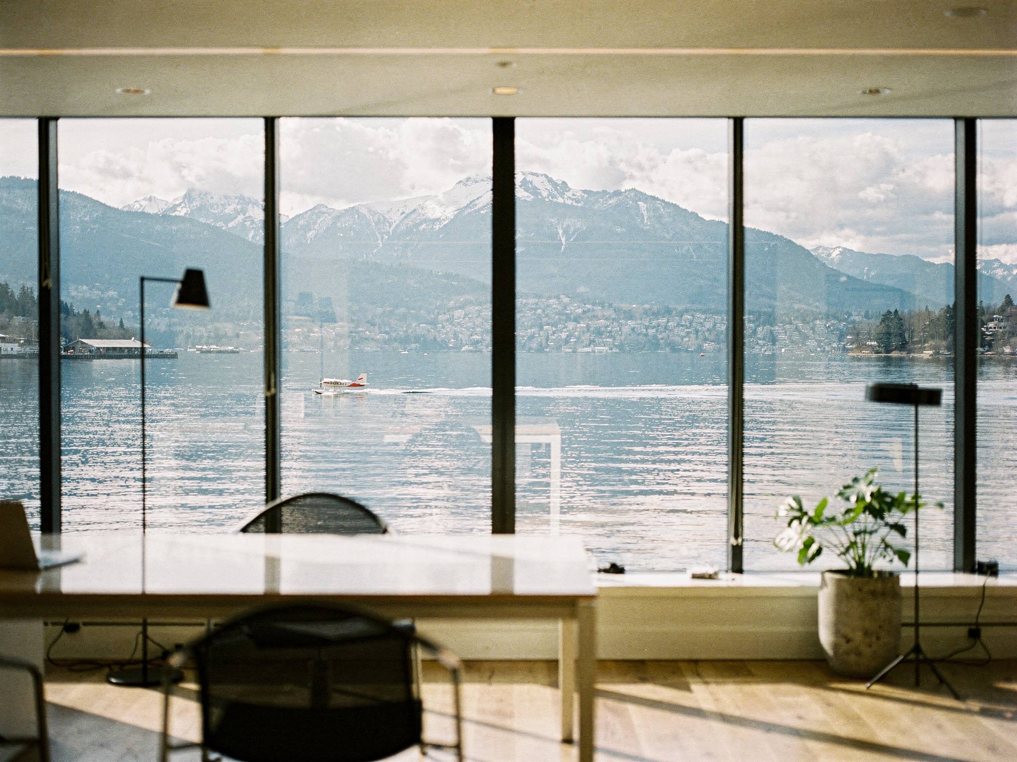 Harbour and North Shore mountains framed through black-mullioned glass