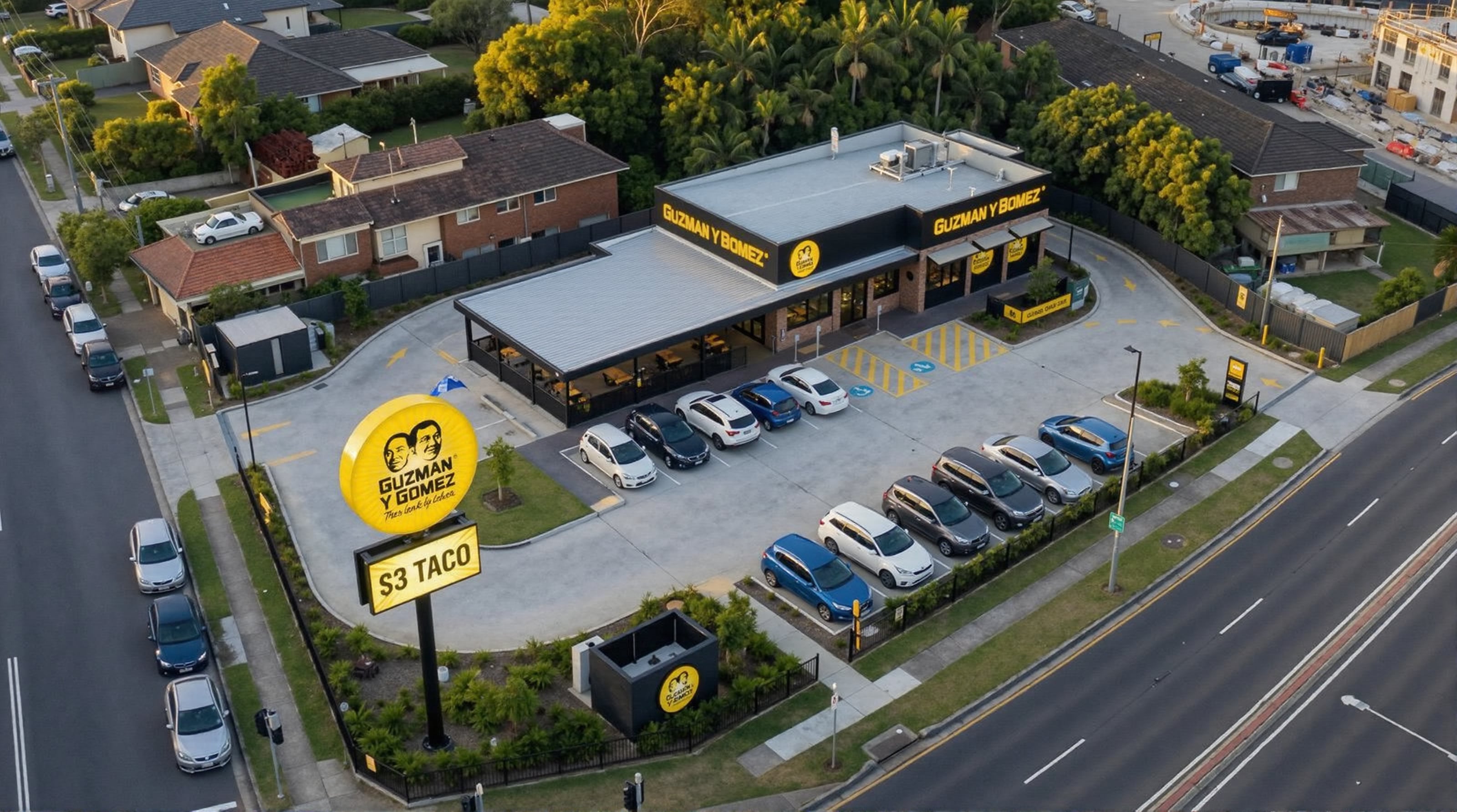 Option B rendered from the air, covered dining terrace to the corner and the drive-thru wrapped behind the building