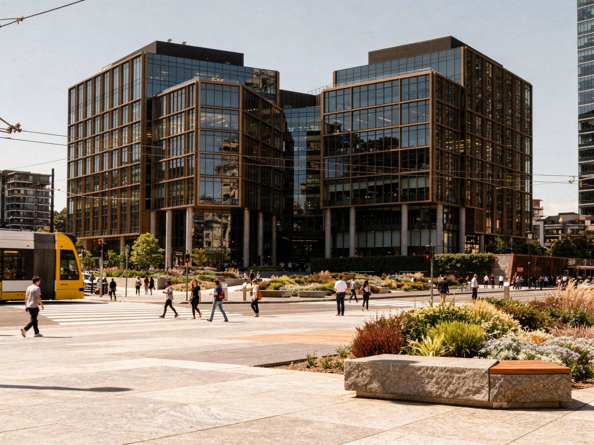 The public plaza at the base of the towers with a passing tram and people