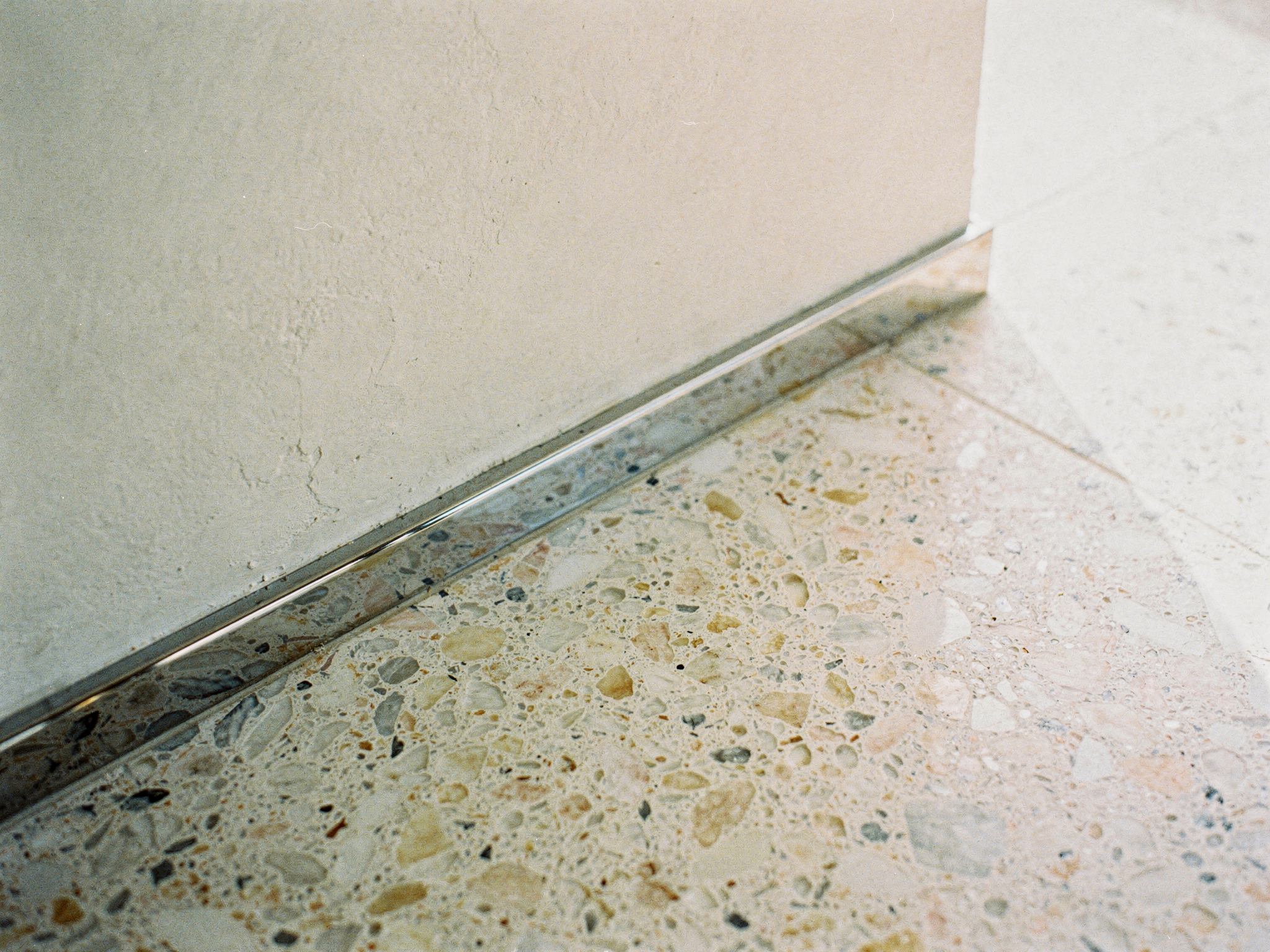 Terrazzo, brass and oak reception desk finishes detail