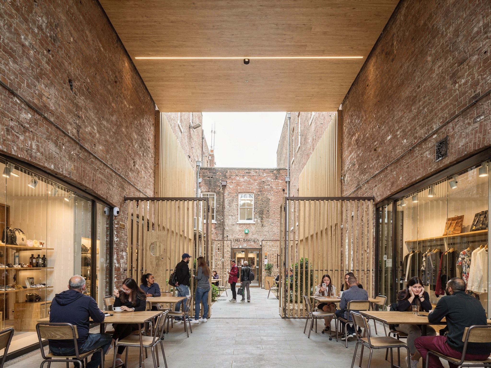 The lane busy on a Saturday with the tenancies open and people at oak tables