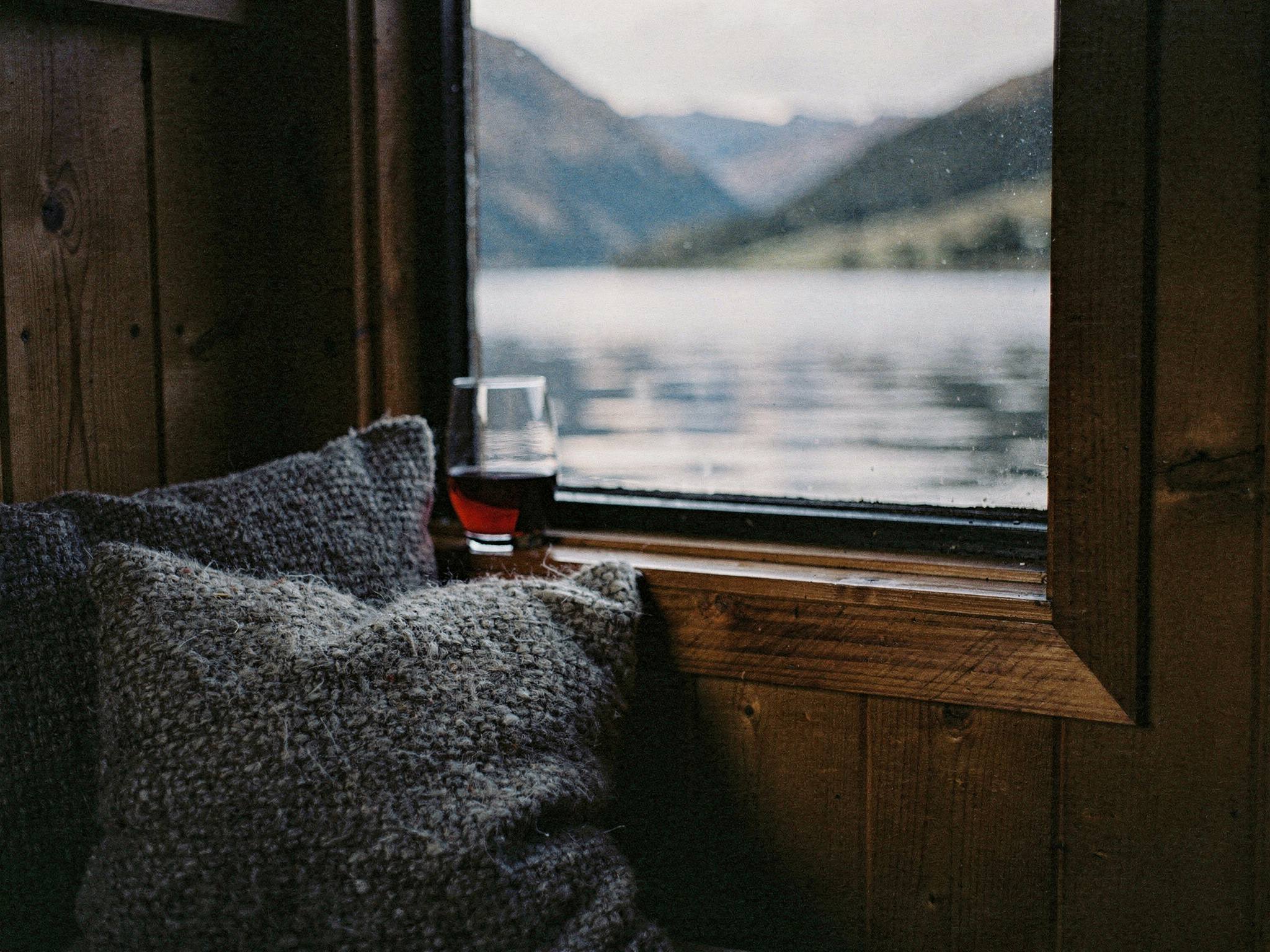 The lake framed from a timber window seat under soft cloud